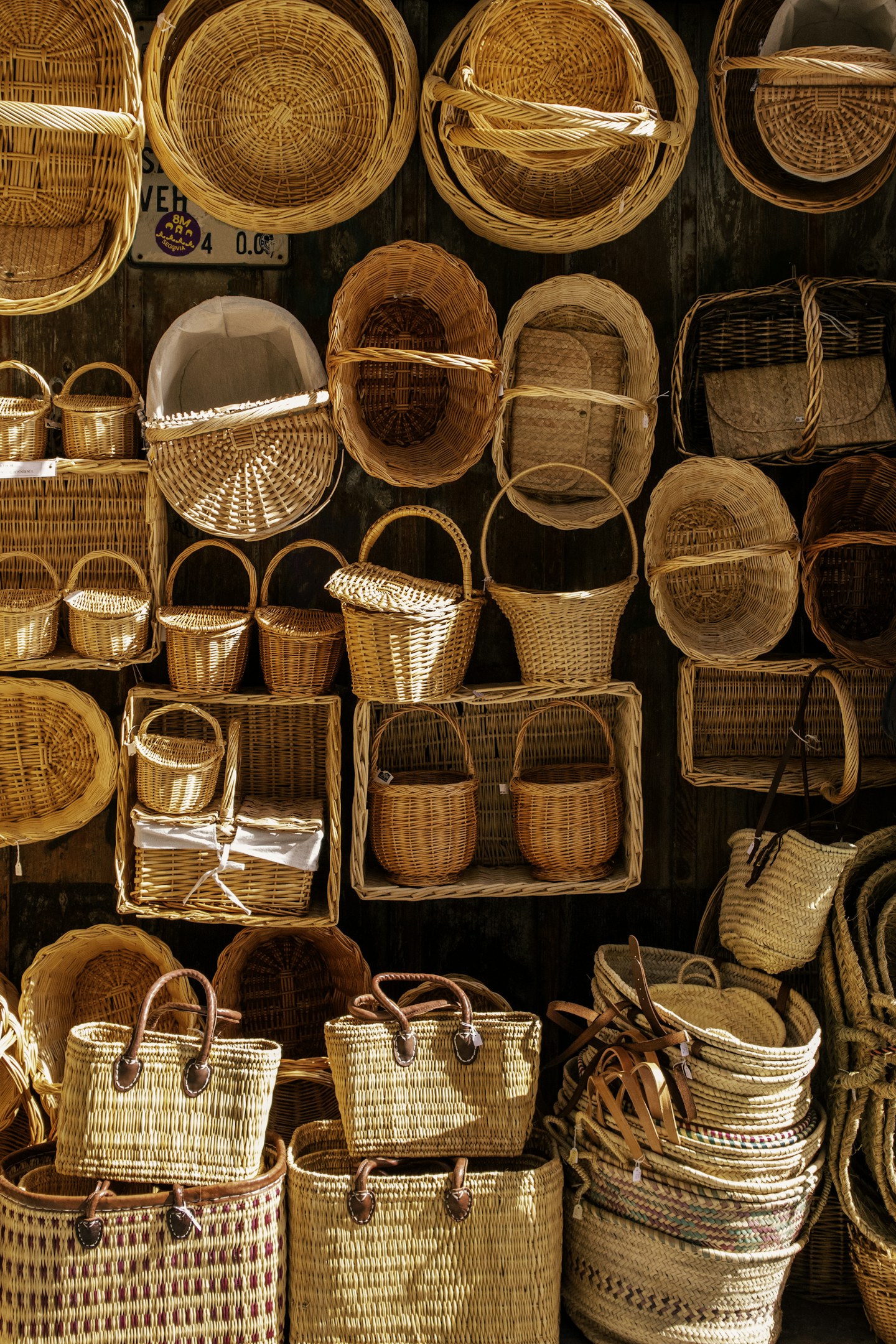 Woven baskets in different sizes displayed together on a wall.