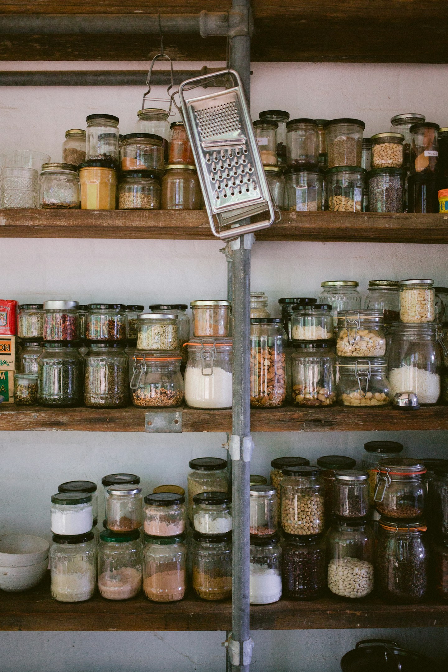 Pantry shelves lined with glass jars of dry ingredients.